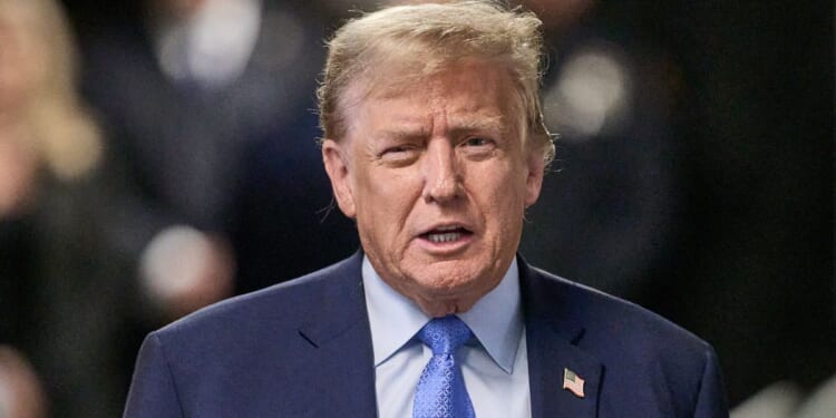 Former U.S. President Donald Trump speaks to the media Friday at the end of the day during his trial in New York City.