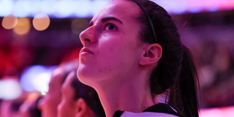 Caitlin Clark of the Iowa Hawkeyes looks on during the National Anthem before playing the South Carolina Gamecocks in the 2024 NCAA Women's Basketball Tournament National Championship in Cleveland, Ohio, on April 7.