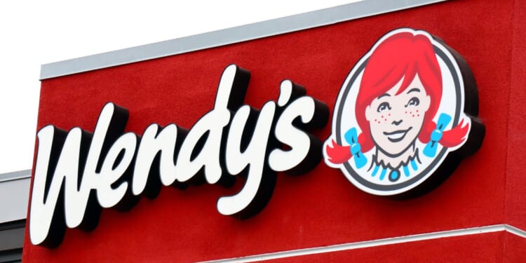 A stock photo shows a sign at a Wendy's restaurant in Los Angeles on June 16.