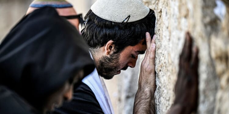 People pray at the Western Wall, the holiest site where Jews are allowed to worship, in the old city of Jerusalem on April 16.