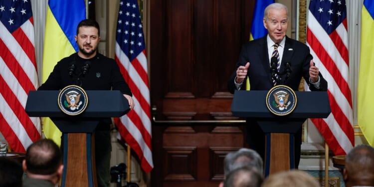 Ukrainian President Volodymyr Zelenskyy and U.S. President Joe Biden hold a news conference in the Indian Treaty Room of the Eisenhower Executive Office Building in Washington on Dec. 12.