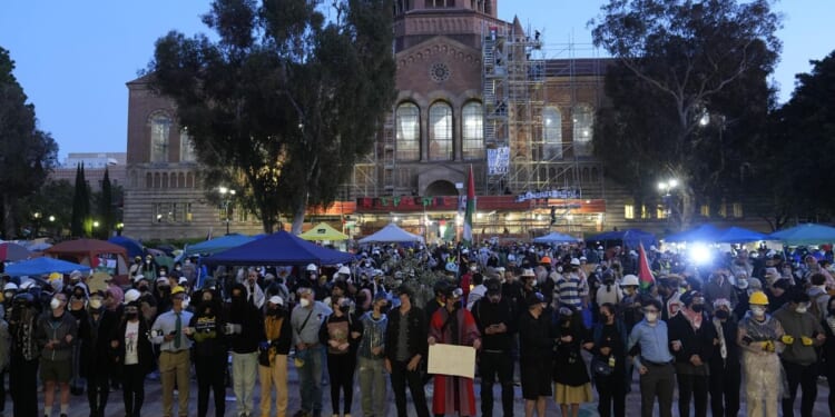 Pro-Palestinian protesters remain on UCLA campus despite police ordering them to leave