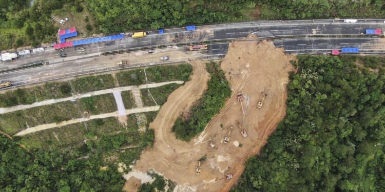 Chinese driver praised for helping reduce casualties in a highway collapse that killed 48