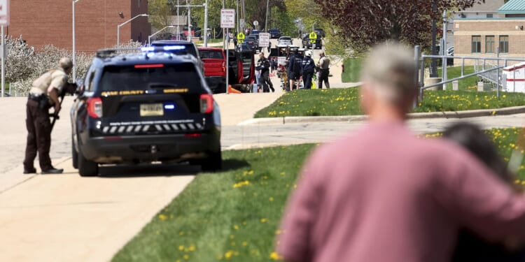 Investigators say student killed by police outside Wisconsin school had pointed pellet rifle