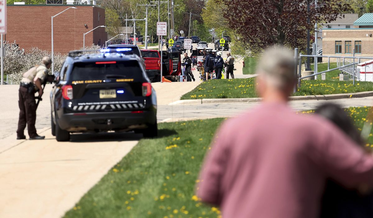 Investigators say student killed by police outside Wisconsin school had pointed pellet rifle