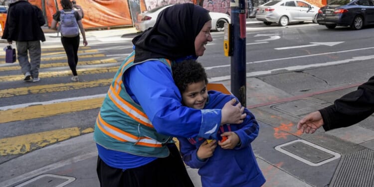 Helpers escort kids through San Francisco's Tenderloin neighborhood