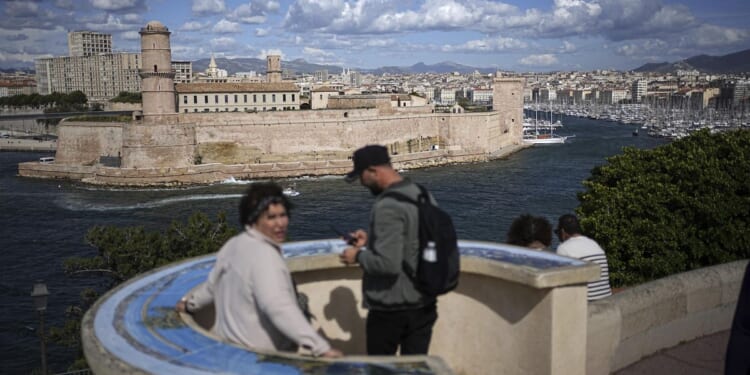 The Olympic torch being welcomed in French port city of Marseille with fanfare and high security