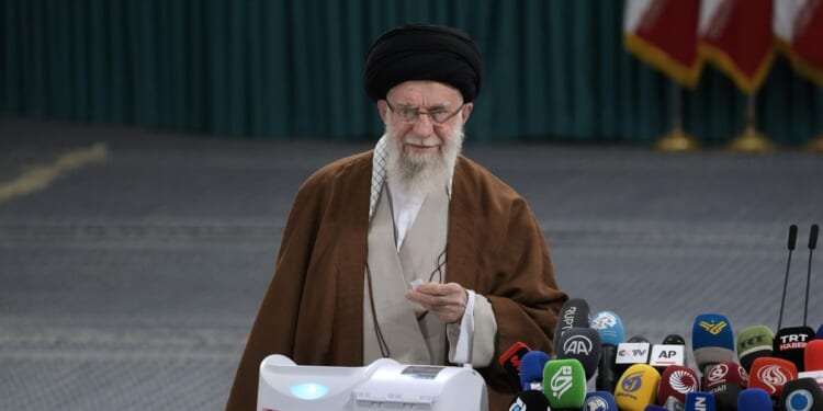 Iranians voting in parliamentary runoff election after hard-liners dominate initial balloting