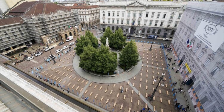 Mock coffins fill a square in Milan in a protest over workplace safety in Italy