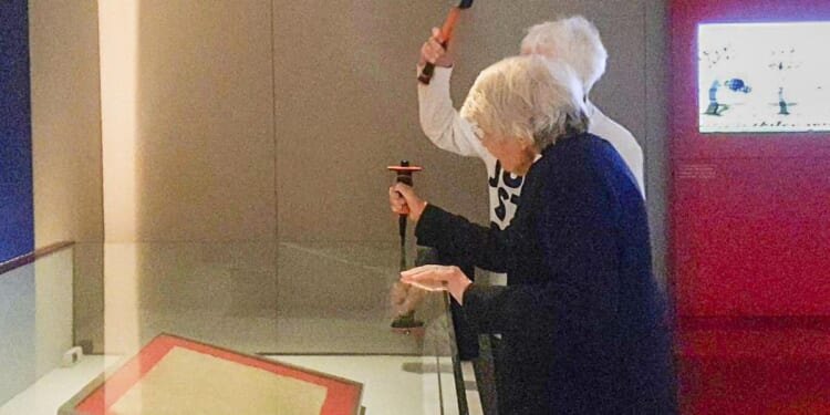 Environmentalists attack glass case holding copy of the Magna Carta in London but document unscathed