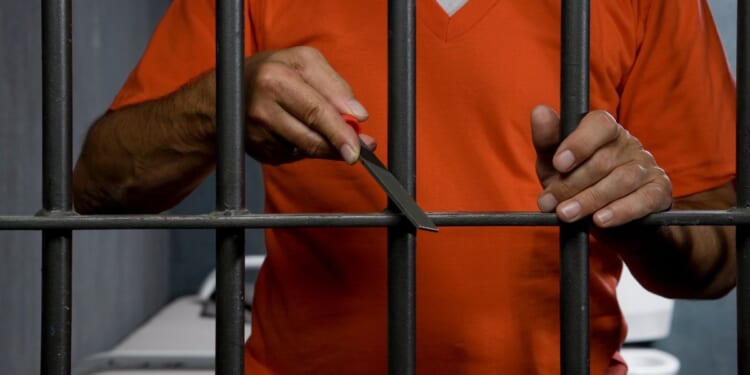 This Getty stock image shows a prison inmate trying to escape his cell.