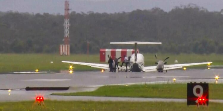 A plane with three aboard lands without landing gear at an Australian airport after burning off fuel