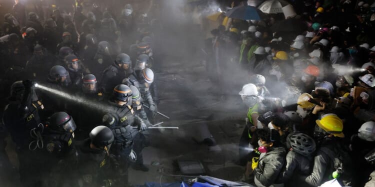 California State Police officers face off with anti-Israel demonstrators after destroying part of the encampment barricade on the campus of the UCLA in Los Angeles early Tuesday morning.