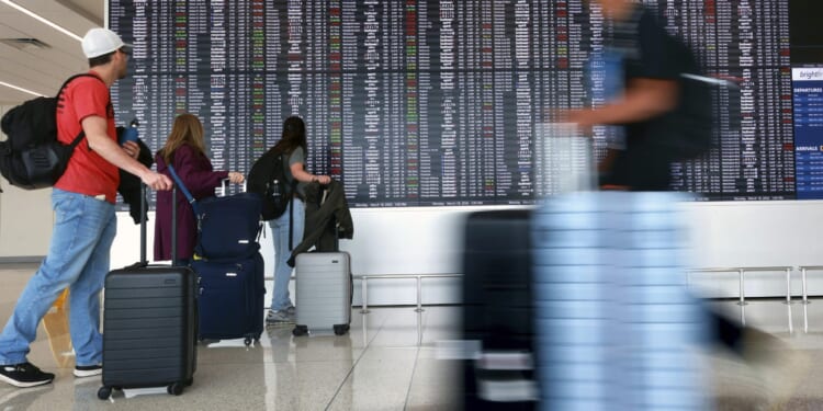 Passengers arrive at Terminal C at Orlando International Airport in Orlando, Florida on March 18.