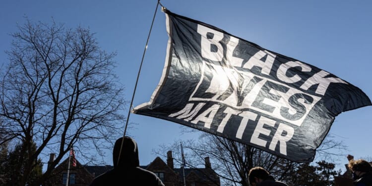 A man holds a Black Lives Matter flag" in St.Paul, Minnesota, in a file photo from March 6, 2021.