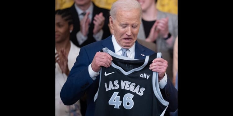 Las Vegas Aces forward A'ja Wilson (not pictured) presents a jersey to U.S. President Joe Biden during a ceremony to celebrate the WNBA Champion Las Vegas Aces in the East Room of the White House on May 9, 2024 in Washington, DC.