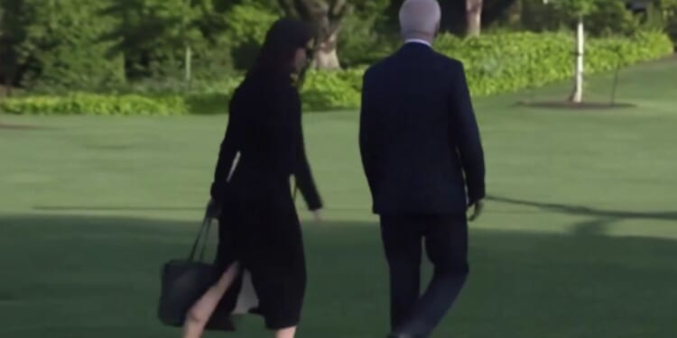 While walking to Marine One on Friday, a White House aid quickly moved from one side of President Joe Biden to the other, in an apparent attempt to shield him from the press.