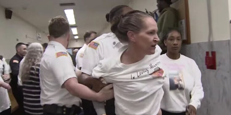 court officers separating brawlers in the aftermath of a physical altercation in a courthouse