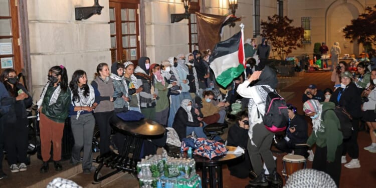 Anti-Israel protesters lock arms to block police from entering Hamilton Hall on the campus of Columbia University in New York City on Tuesday.