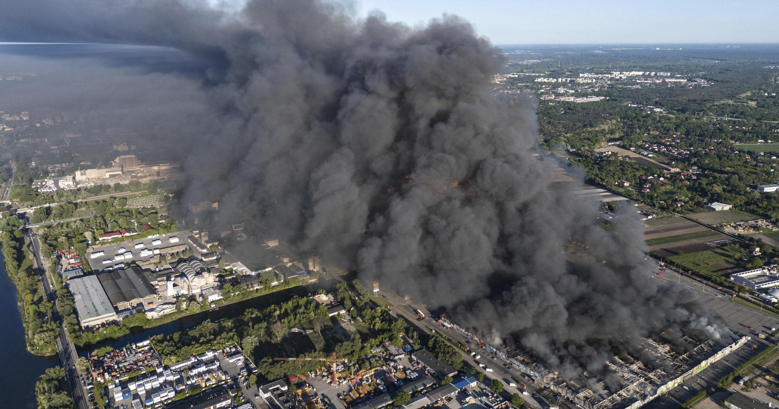 A fire burns from a vast shopping complex in Warsaw, Poland, on Sunday, May 12, 2024. The fire broke out Sunday morning in a vast shopping complex in the Polish capital that housed some 1,400 shops and service outlets and where many of the vendors were from Vietnam.