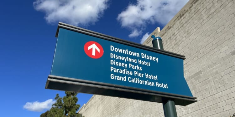 A sign directing traffic towards Downtown Disney and other Disney locations in Anaheim, California.