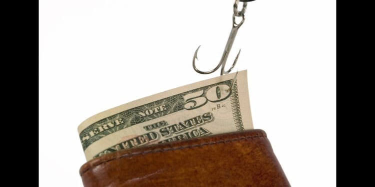 This Getty stock image shows a $50 bill stuck on a fishing hook, being pulled out of a wallet.