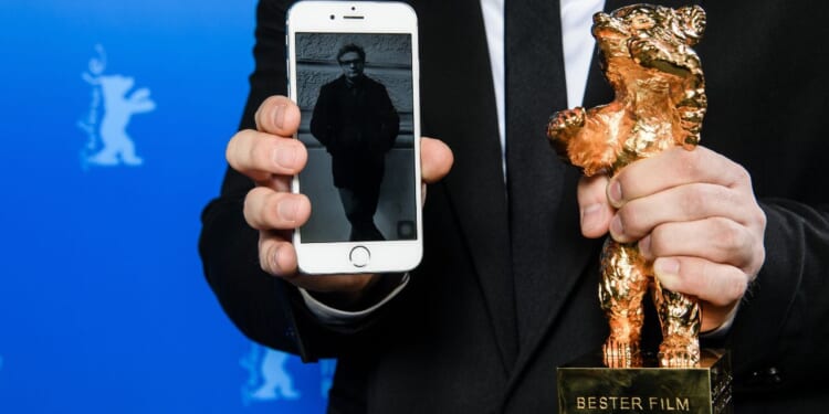 An image of Iranian director Mohammad Rasoulof, winner of the Golden Bear for Best Film for the film "There Is No Evil," is shown next to his award at the award winners news conference during the 70th Berlinale International Film Festival Berlin in Berlin, Germany, on Feb. 29, 2020.