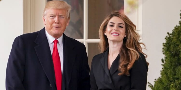 Donald Trump posing with Hope Hicks on her last day on the South Lawn of the White House