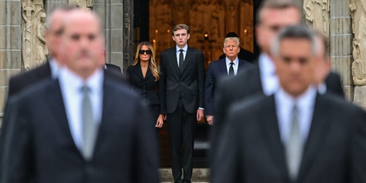 Donald Trump stands with Melania Trump and their son Barron Trump