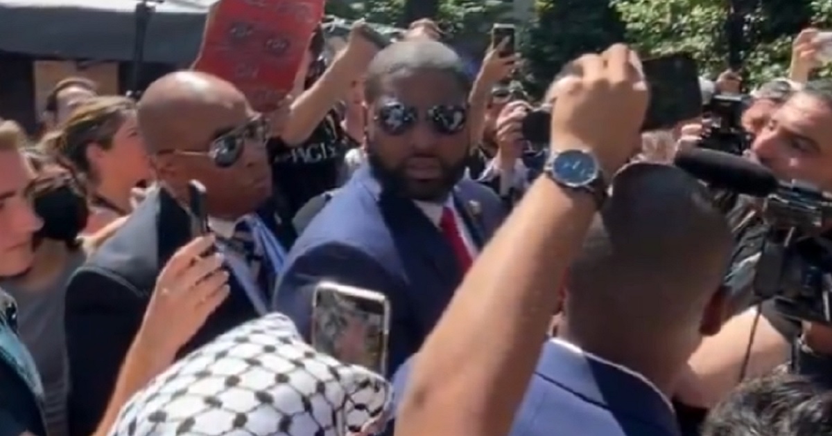 U.S. Rep. Byron Donalds of Florida turns to face a heckler on Wednesday on the campus of George Washington University.