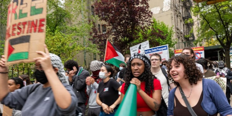 are seen walking from Columbia University to Hunter College as protests at area universities and colleges continued May 6 in New York City.