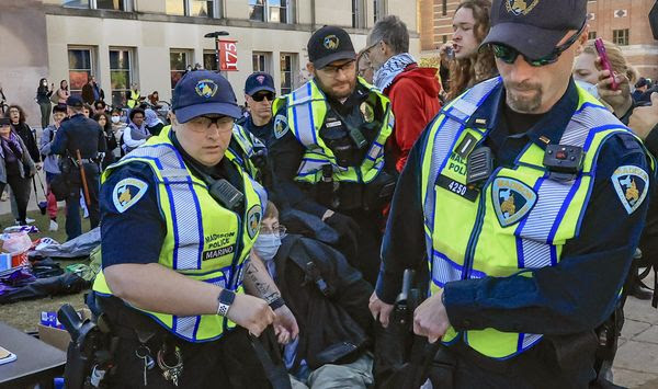 Madison Police carry a demonstrator protesting the war in Gaza as they work to remove a non-sanctioned encampment on the campus of UW-Madison in Madison, Wis., on Wednesday, May 1, 2024. (John Hart/Wisconsin State Journal via AP)