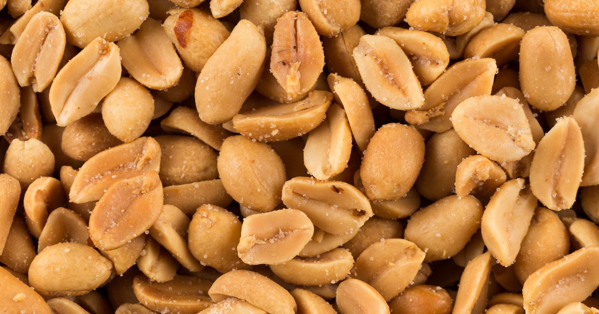 This stock image shows a close up of salted peanuts.