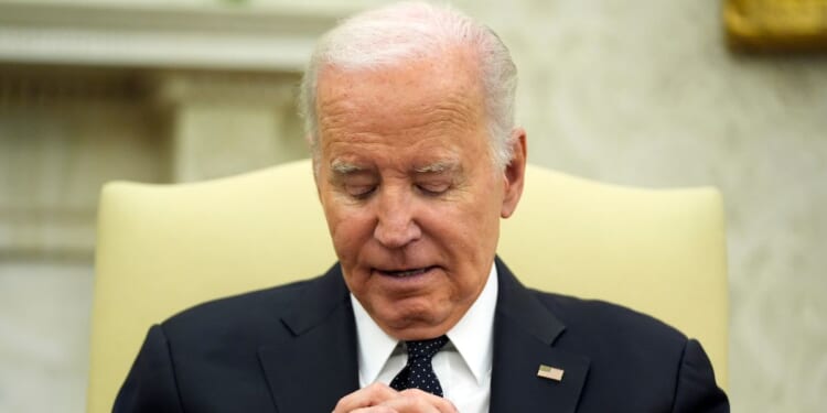 Joe Biden listening to Romania's President Klaus Iohannis in the Oval Office