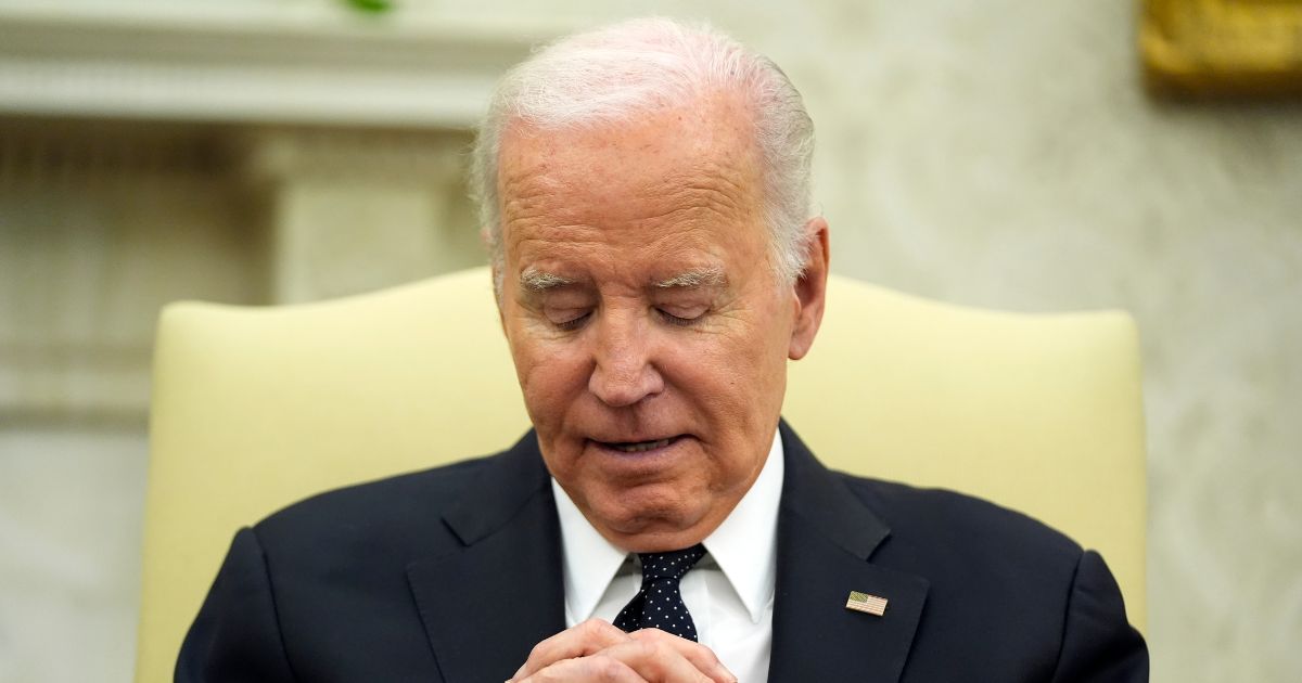 Joe Biden listening to Romania's President Klaus Iohannis in the Oval Office