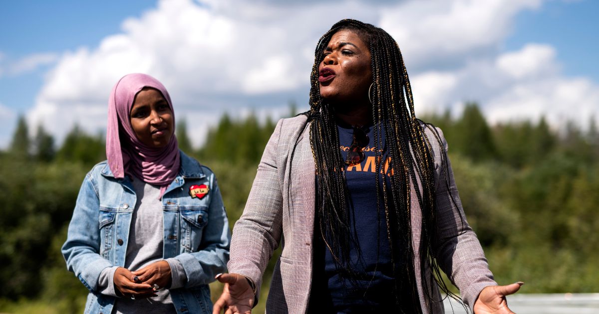 Rep. Ilhan Omar watches as Rep. Cori Bush speaks while visiting the headwaters of the Mississippi River where the Line 3 Pipeline is being constructed on September 4, 2021 in Park Rapids, Minnesota.