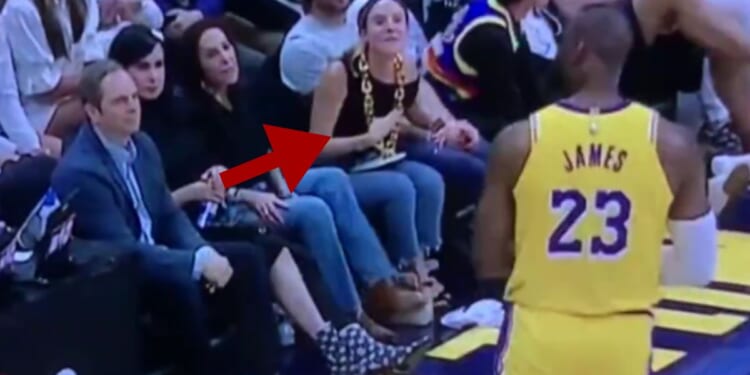 During the Los Angeles Lakers' loss to the Denver Nuggets on Monday, LeBron James, right, had a fit on the court and seemingly tried to jump scare a fan, center, that called him a "cry baby."