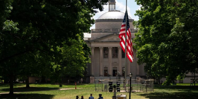 A barricade protects the American flag at Polk Place at the University of North Carolina on Wednesday in Chapel Hill, North Carolina. On Tuesday, protesters removed an American flag and raised a Palestinian flag following a dispersed encampment at Polk Place on the campus of the University of North Carolina.