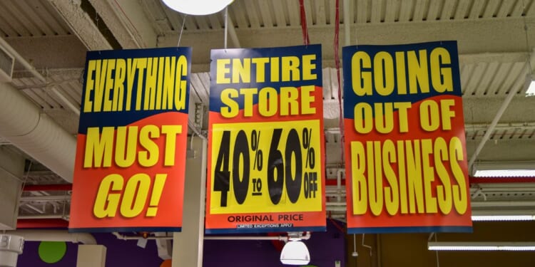 A stock photo shows signs in a store that's going out of business.