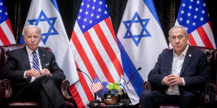 President Joe Biden sits with Israeli Prime Minister Benjamin Netanyahu at the start of the Israeli war cabinet meeting in Tel Aviv on Oct. 18.