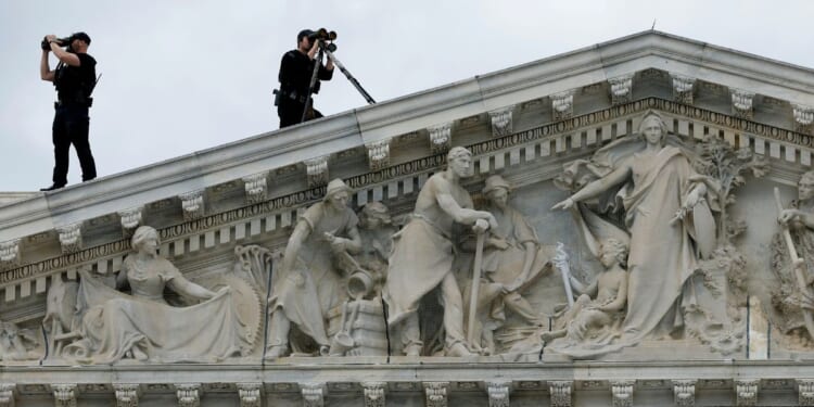 Members of the U.S. Secret Service Counter-Sniper team set up watch from the roof of the House of Representatives in Washington, D.C., as President Joe Biden arrives at the U.S. Capitol in a file photo from March 15, 2023.