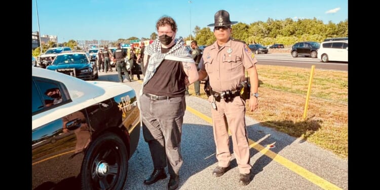 Queers for Palestine protesters who blocked Interstate 4 in Orlando, Florida, are arrested by the Florida Highway Patrol.