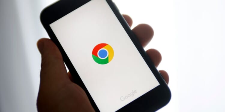 A photo illustration shows the Google Chrome logo displayed on the screen of an iPhone in Paris on June 8, 2023.