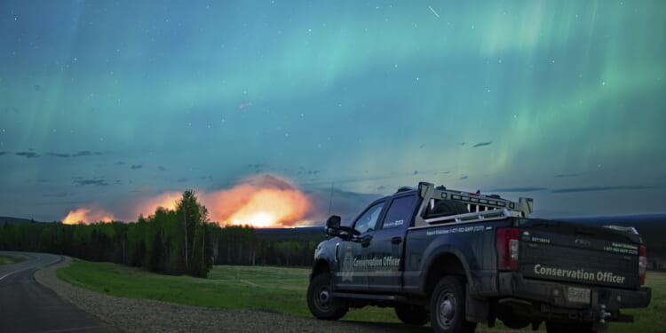 An Aurora Borealis is pictured near Fort Nelson, British Columbia, on Saturday. An intense wildfire could hit a town in western Canada on Monday, based on forecasts of strong winds that have been fueling the out-of-control blaze which has already forced the evacuation of thousands, fire experts and officials warned.