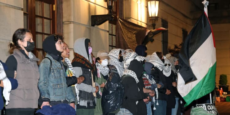 Anti-Israel protesters lock arms at the entrance to Hamilton Hall on the campus of Columbia University in New York City on Tuesday.