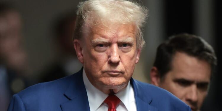 Former President Donald Trump walks to speak to members of the media at the end of the day at his trial at Manhattan Criminal Court in New York City on Monday.