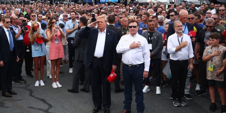 Former U.S. President and Republican presidential candidate Donald Trump stands on the grid with NASCAR team owner Richard Childress prior to the NASCAR Cup Series Coca-Cola 600 at Charlotte Motor Speedway on May 26, 2024 in Concord, North Carolina.