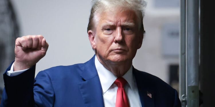 Former President Donald Trump gestures as he returns from a break during his trial at Manhattan criminal court in New York City on Monday.