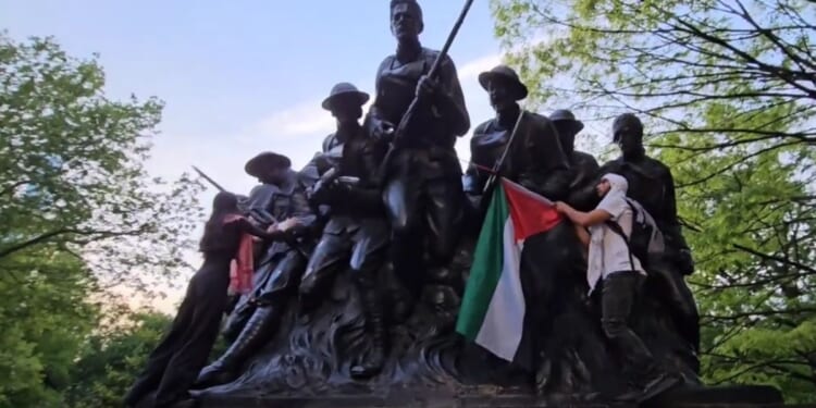 Anti-Israel protesters deface the 107th Infantry Memorial in New York's Central Park on Monday.