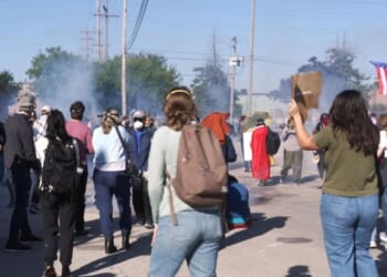 Federal agents fire chemicals as protesters attempt to block car at immigration site outside Chicago